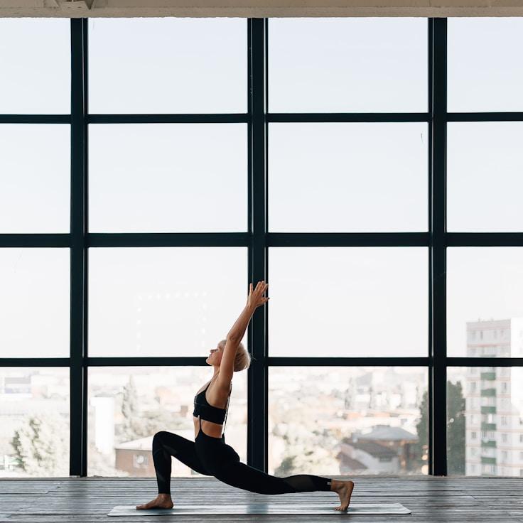 Women in a fitness class doing stretching and mobility exercises